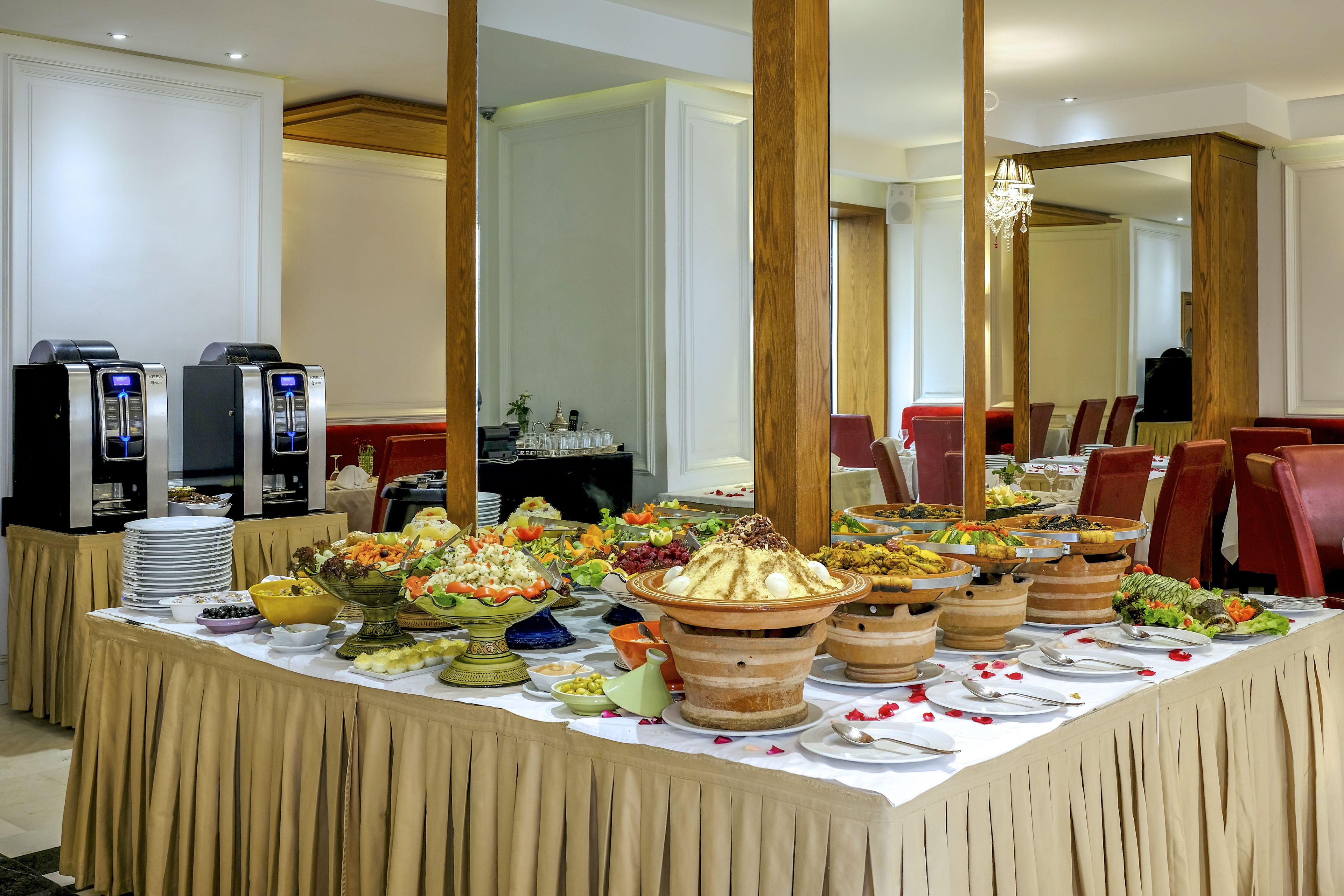 A buffet setup with various food items and a coffee station.