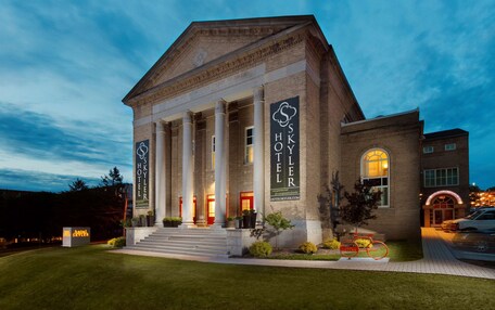 A hotel with a classical facade, large columns, and a prominent entrance.