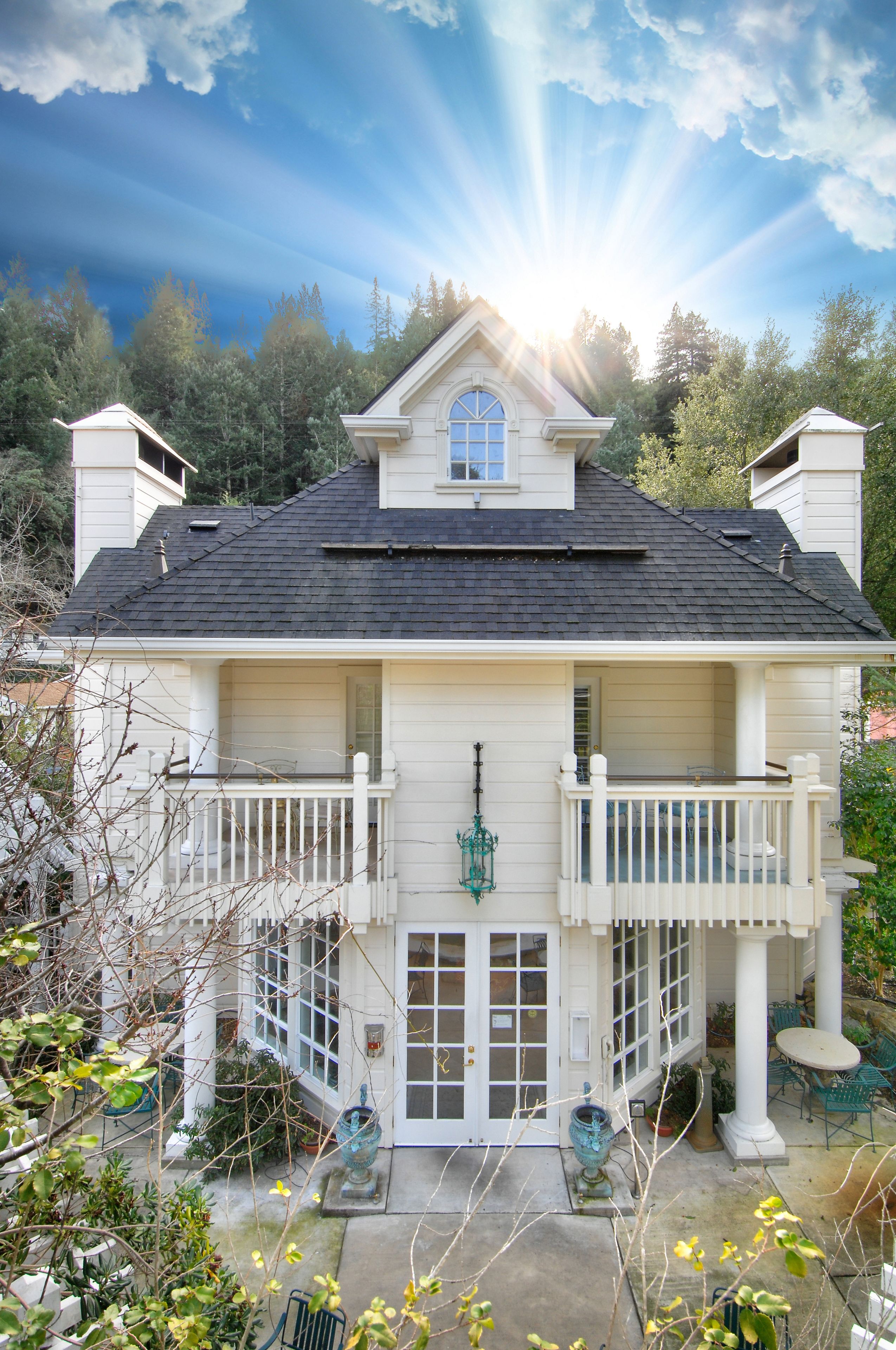 A two-story house with a balcony, a front porch, and a garage.