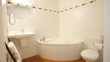 A bathroom with a sink, a bathtub, and a toilet.