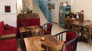 A cozy interior with a staircase, wooden furniture, and a vintage sewing machine. - Al-Mutran Guest House (Nazareth)