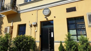 A building with a sign reading "Sleep Well" indicating a hotel or accommodation. - SleepWell Apartments Nowy Świat (Warsaw)