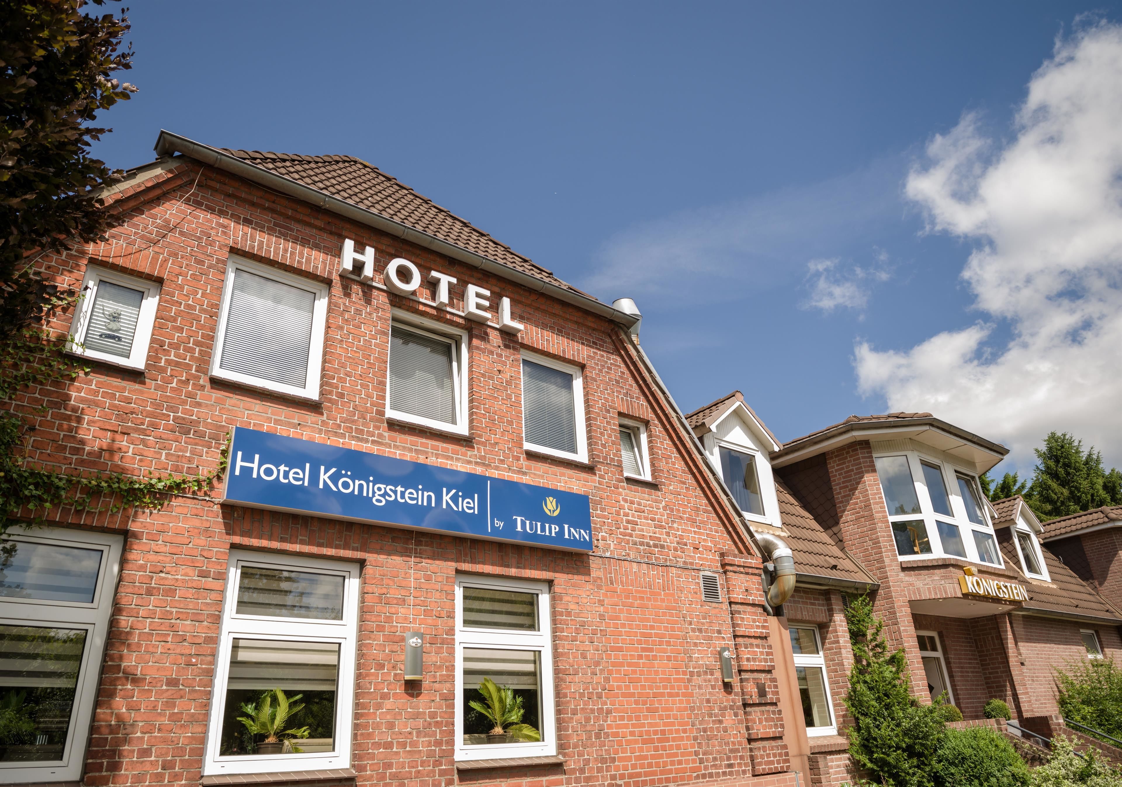 A hotel named Hotel Königstein Kiel with a sign indicating it's by Tulip Inn.