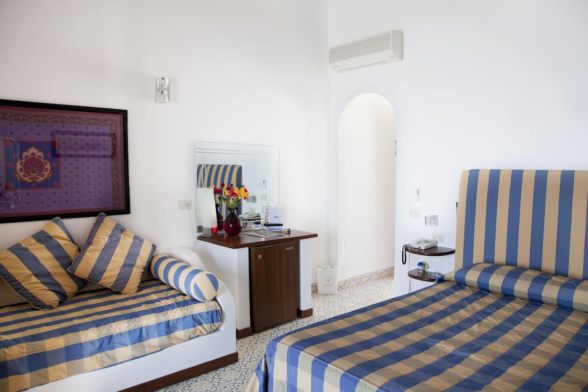 superior triple room, terrace, sea view | minibar, in-room safe, desk, cots/infant beds