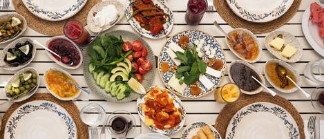 A table set with various dishes, including eggs, vegetables, and sauces, suggesting a meal setting.