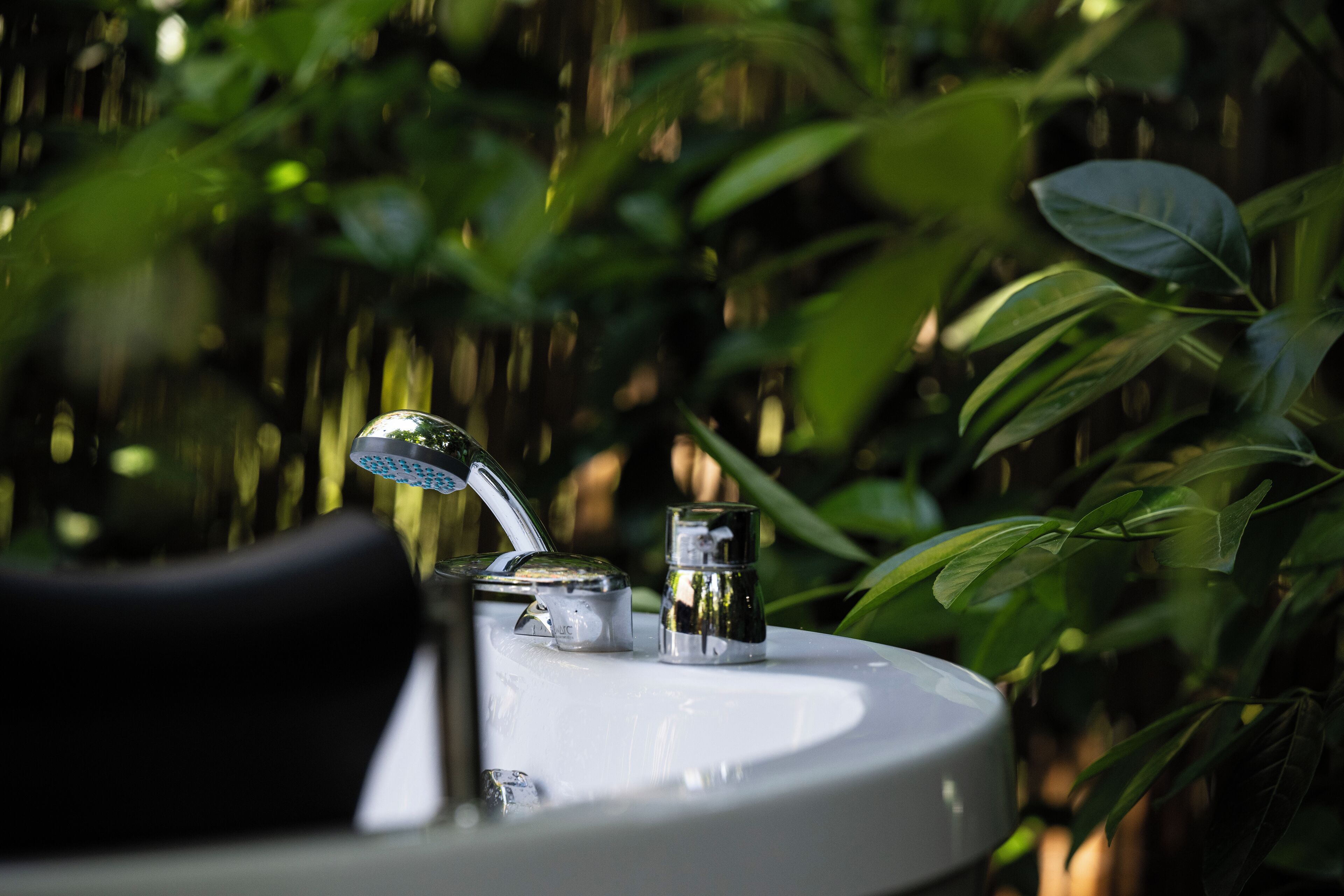 A bathroom sink with a faucet and a soap dispenser.