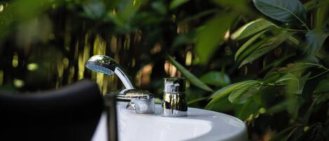 A bathroom sink with a faucet and a soap dispenser.