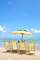 On the beach, white sand, beach umbrellas, beach towels