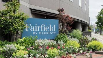A sign for Fairfield by Marriott with a landscaped garden in front.