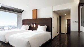 A hotel room with two beds, a large window with a city view, a wooden headboard, and a modern design. - Fairfield by Marriott Sapporo (Sapporo)