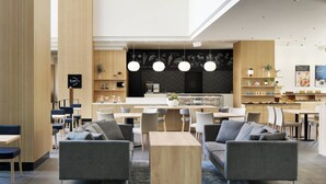 A modern interior with a central seating area, a kitchen, and a bar. - Fairfield by Marriott Sapporo (Sapporo)