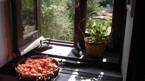 A window with a fruit basket and a potted plant on the windowsill. - Casa Migliaca (Pettineo)