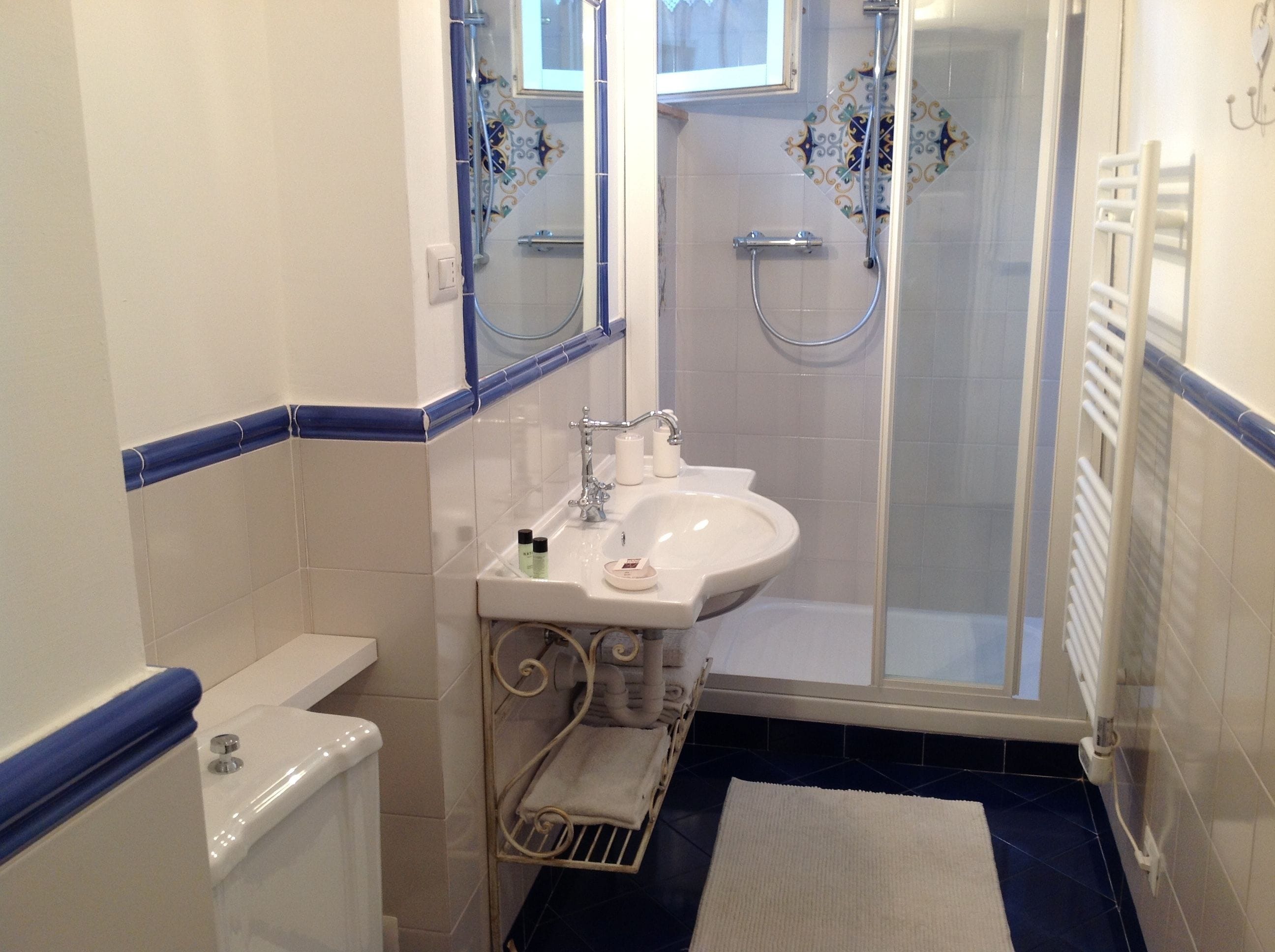 A bathroom with a shower, toilet, and sink.