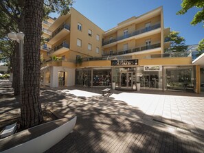 A hotel with a modern facade, multiple balconies, and a clear entrance. - Hotel Colombo (Riccione)