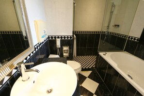 A bathroom with a checkered floor, a white sink, a toilet, and a bathtub. - Rido Hotel (Taipei)