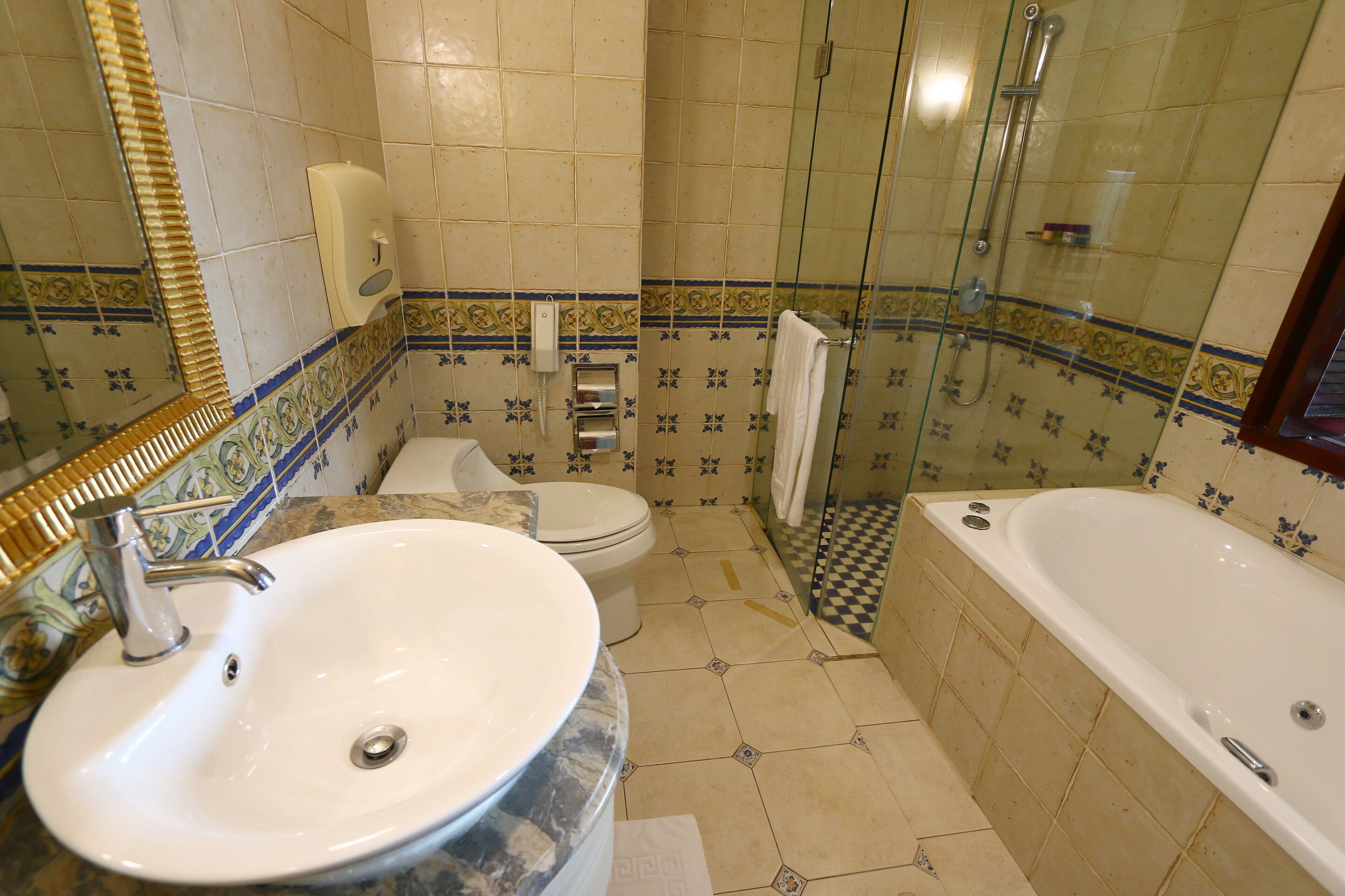 A bathroom with a sink, toilet, shower, and bathtub.