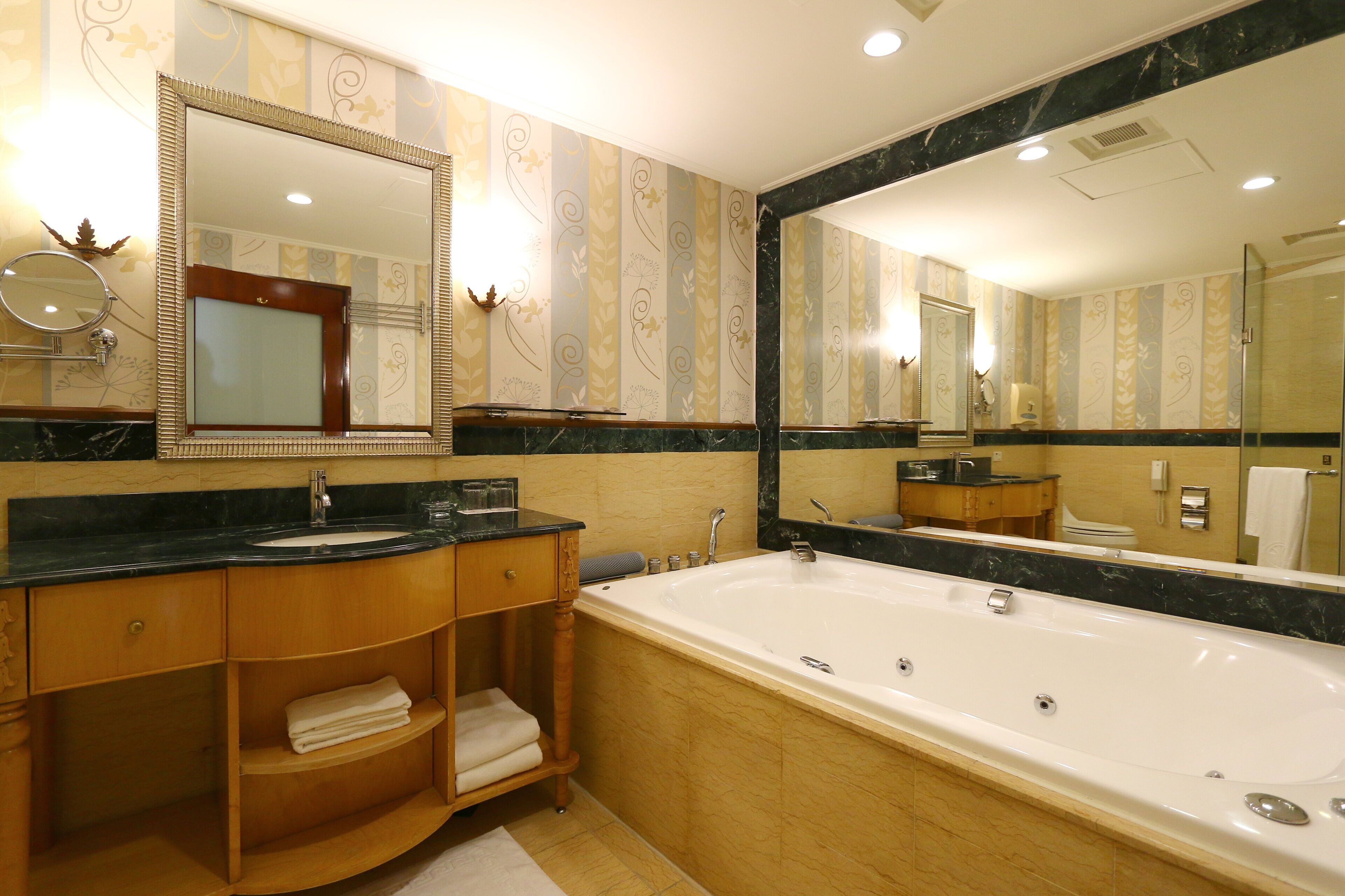 deluxe room | bathroom | separate bathtub and shower, jetted bath, rainfall showerhead