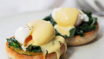A plate with two eggs benedict sandwiches.
