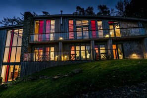 A modern two-story building with large windows and a stone facade. - Dome House (Windermere)