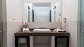 A modern bathroom with a large mirror, a sink, and a telephone.
