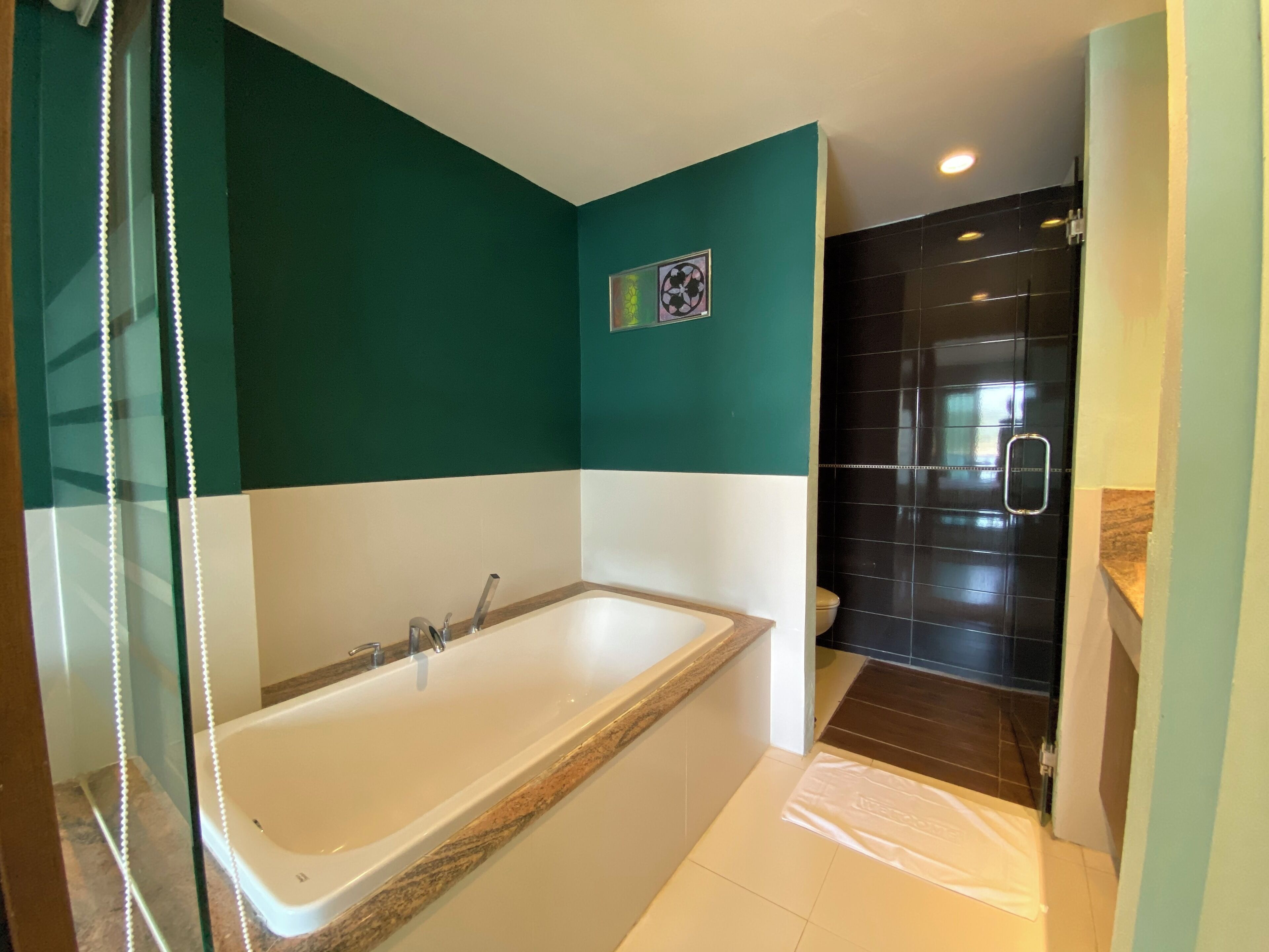 Un baño con bañera, ducha y retrete.