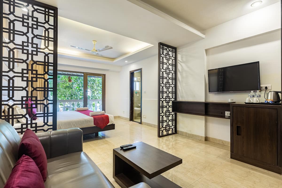 A modern living room with a sofa, coffee table, and a TV mounted on the wall.