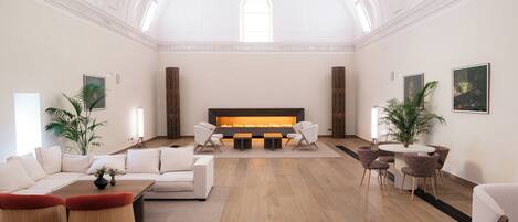 Un vestíbulo amplio con chimenea, zona de estar y decoración moderna.