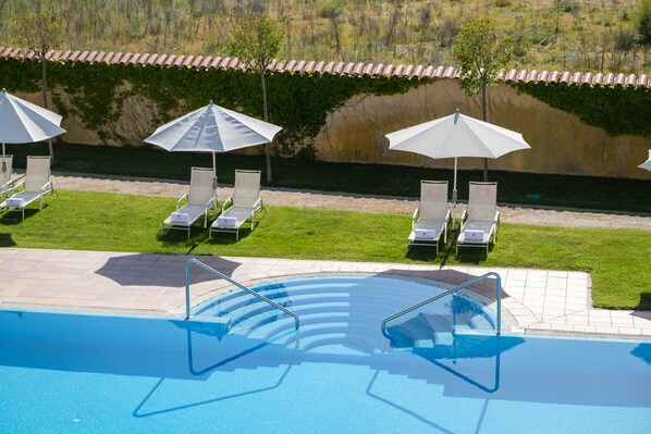 Indoor pool, seasonal outdoor pool, pool umbrellas, pool loungers