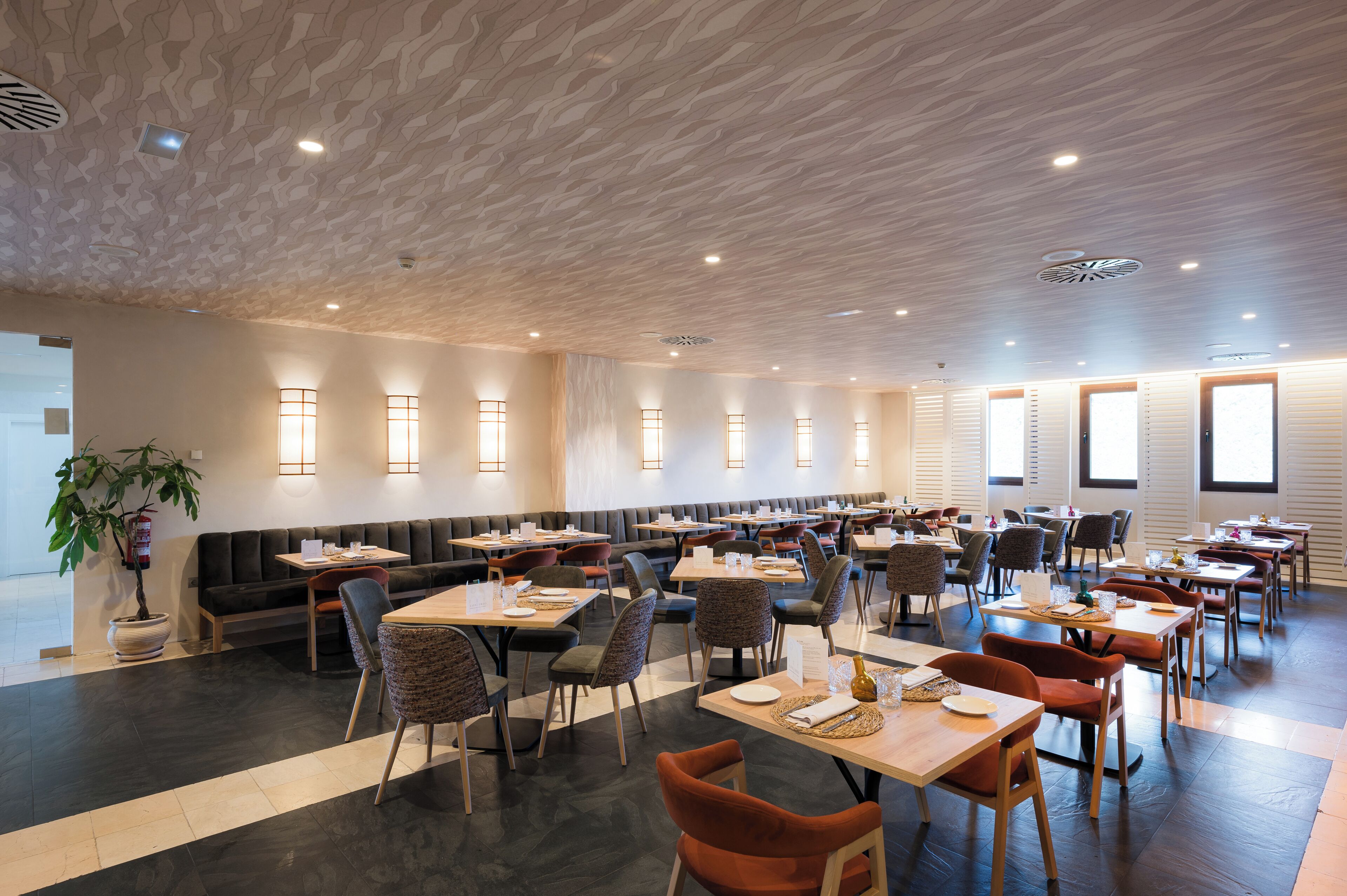 A spacious restaurant with high ceilings and modern lighting.