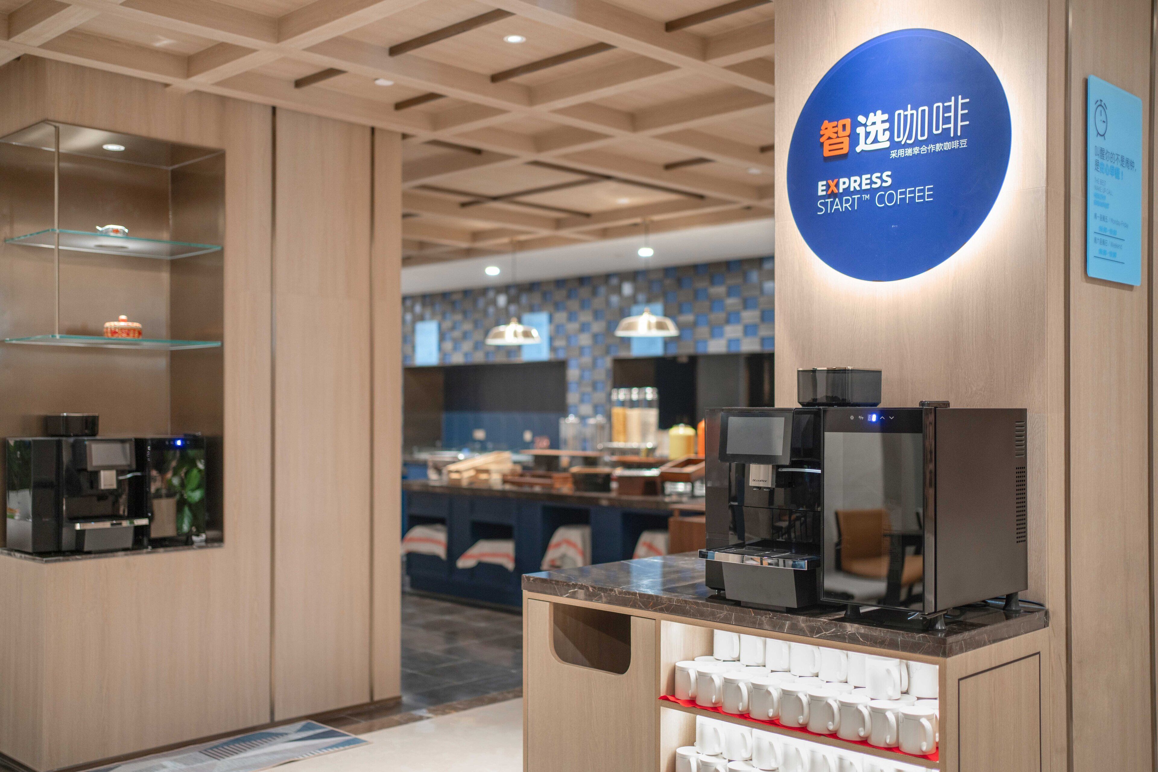 A modern coffee station with espresso machines and a coffee dispenser.