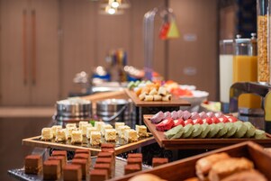 A buffet with various desserts and pastries.