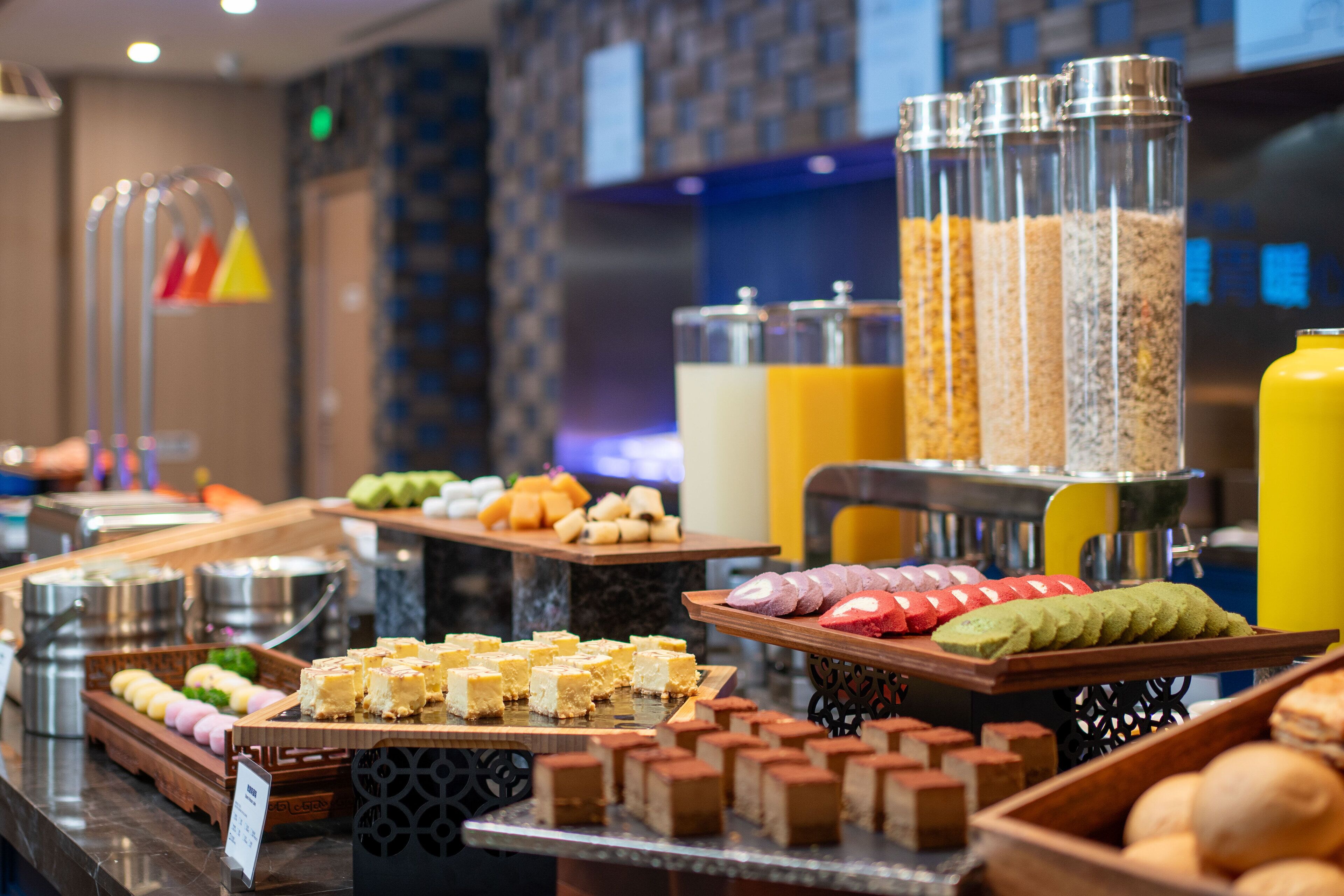 A buffet with various food items and beverages.