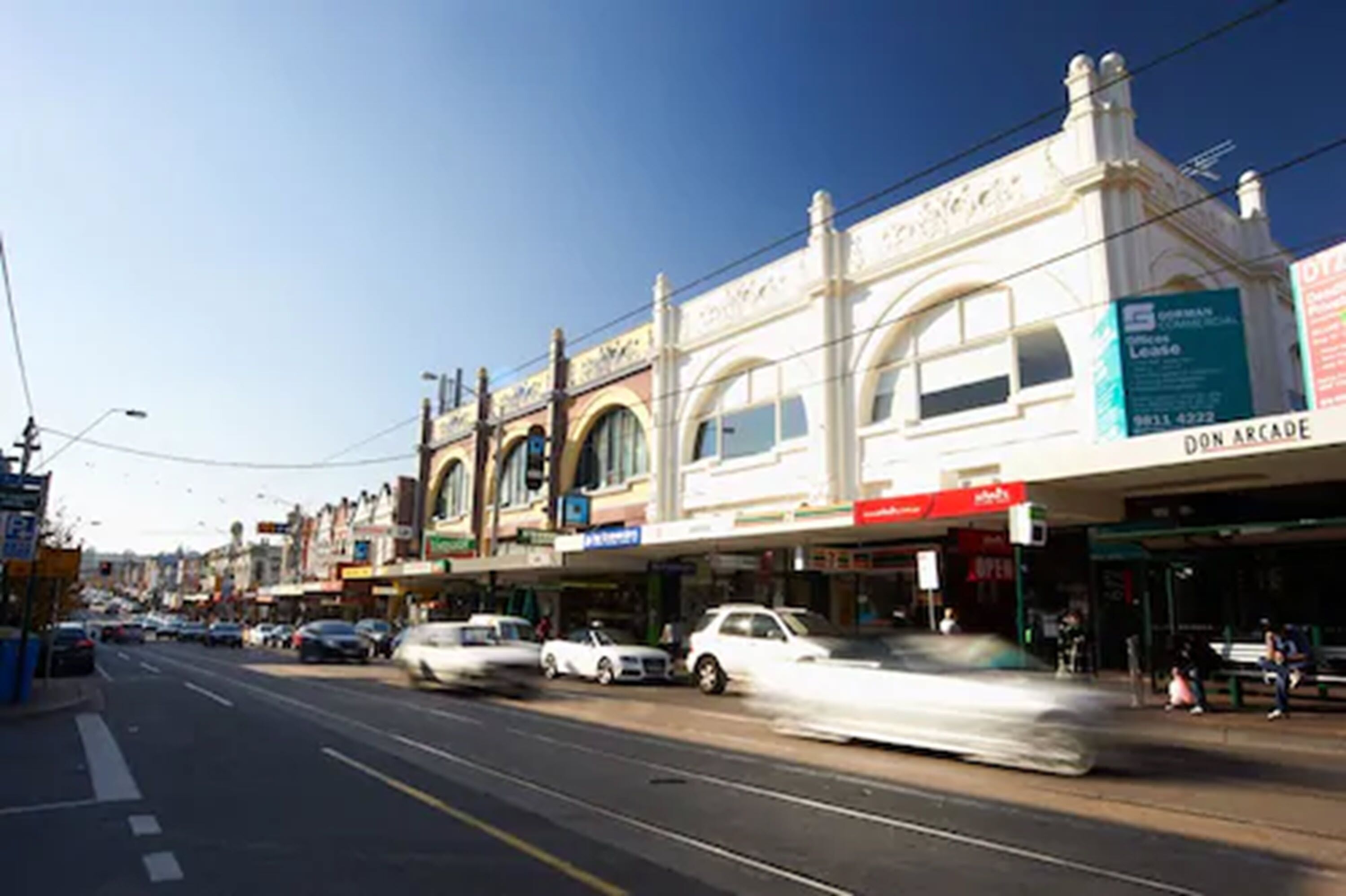 A street with buildings, including a visible sign for 'Don Arcade'.
