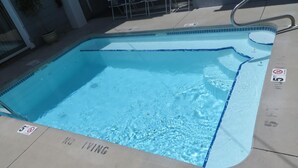 A rectangular pool with a blue border and a 'No Diving' sign. - Sea Breeze Inn (Ocean City)