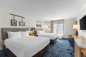 A hotel room with two beds, a desk, a TV, and a window with curtains. - Sleep Inn & Suites Fort Campbell (Oak Grove)