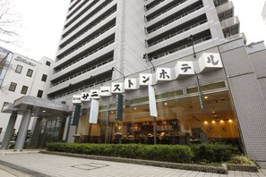 A hotel with a modern facade, multiple floors, and a prominent entrance with signage. - Shin Osaka Sunny Stone Hotel (Osaka)
