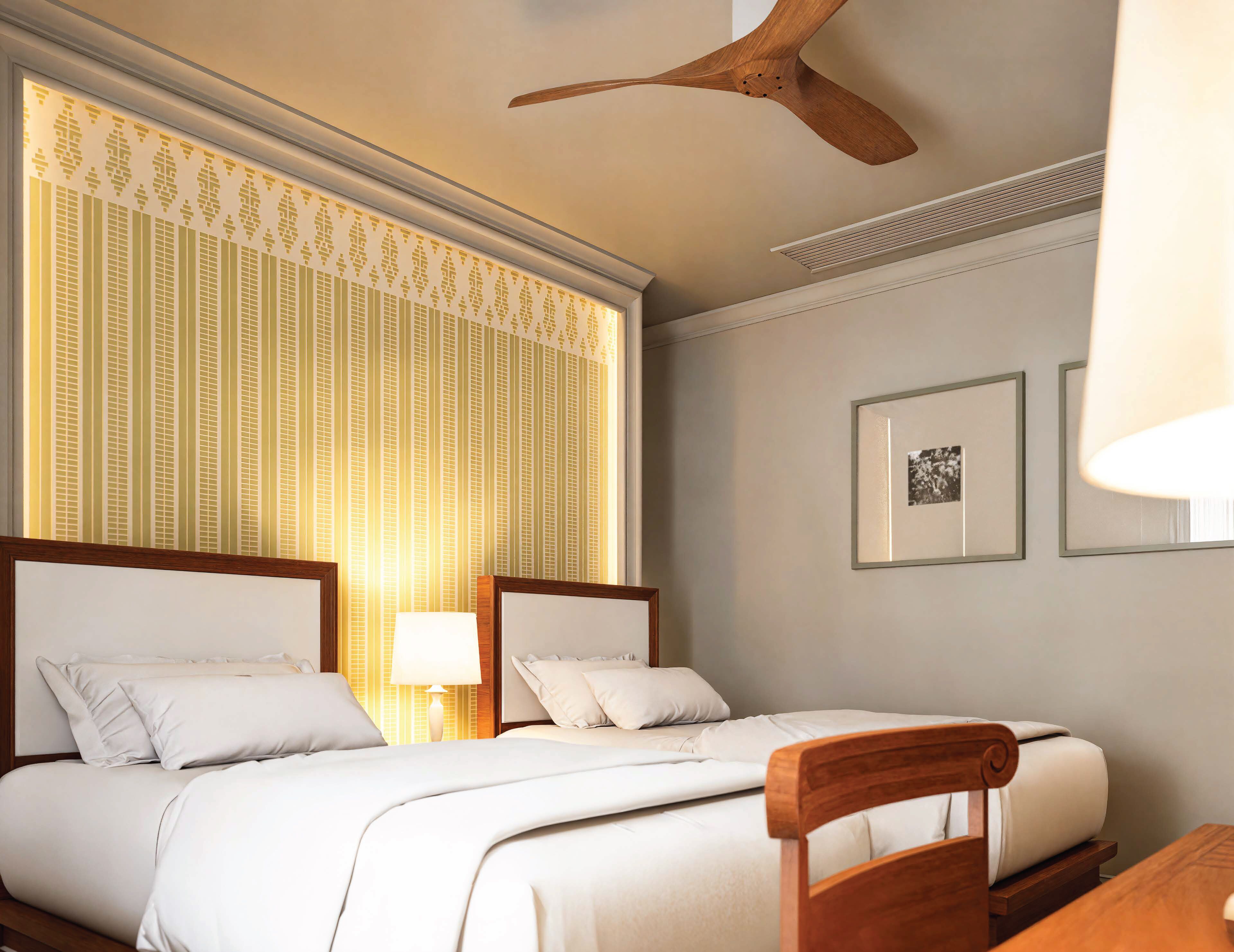 A hotel room with two beds, a wooden ceiling fan, a window with striped curtains, and framed pictures on the wall.