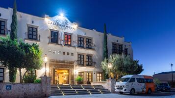 Vista frontal de la propiedad por la tarde o noche