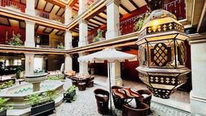 A spacious atrium with multiple levels, featuring a central fountain, outdoor seating, and ornate lanterns. - Casa Primavera Hotel Boutique & Spa (San Miguel de Allende)