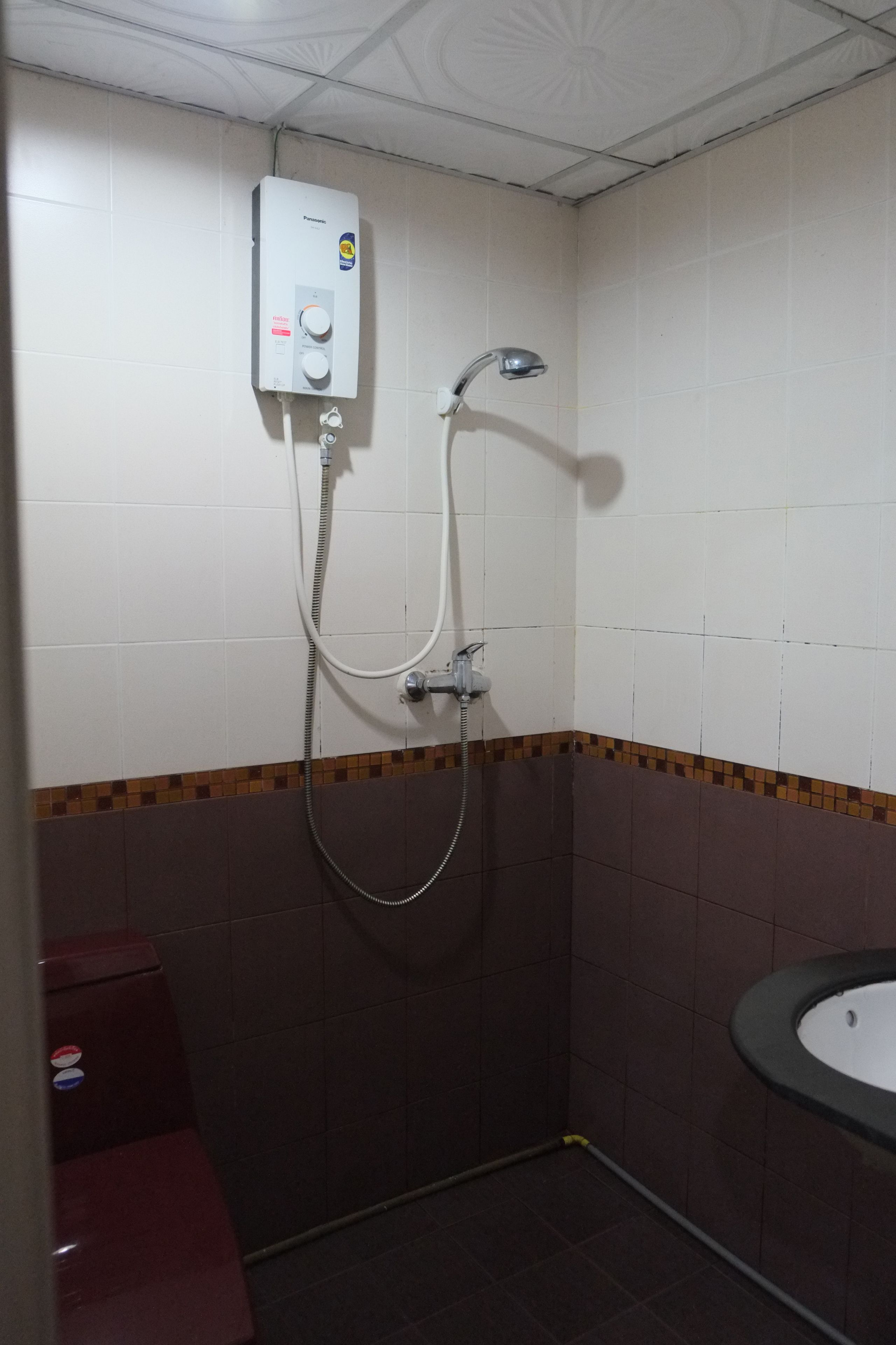 A bathroom with a shower, a toilet, and a sink.