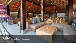 A spacious indoor area with high ceilings, wooden beams, and a mix of seating arrangements including sofas and tables. - Grand Barong Resort (Kuta)
