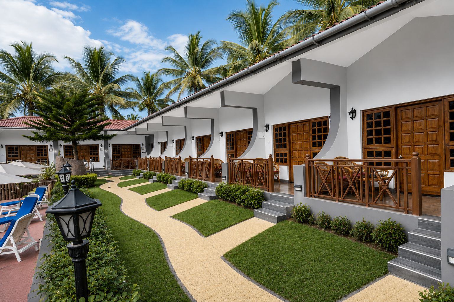 Un resort con varias habitaciones, un patio central con un sendero y palmeras.