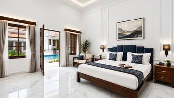A spacious bedroom with a large bed, a view of a swimming pool, and a modern design.