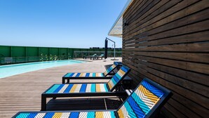 A poolside area with lounge chairs and a pool. - aha Gateway Hotel (Umhlanga)