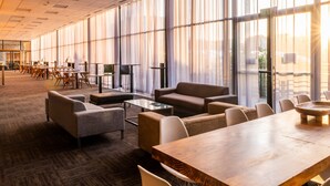 A spacious conference room with large windows, a long table, and several chairs. - aha Gateway Hotel (Umhlanga)