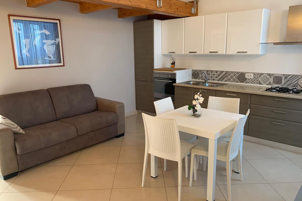 deluxe studio, 1 double bed with sofa bed | living room | flat-screen tv