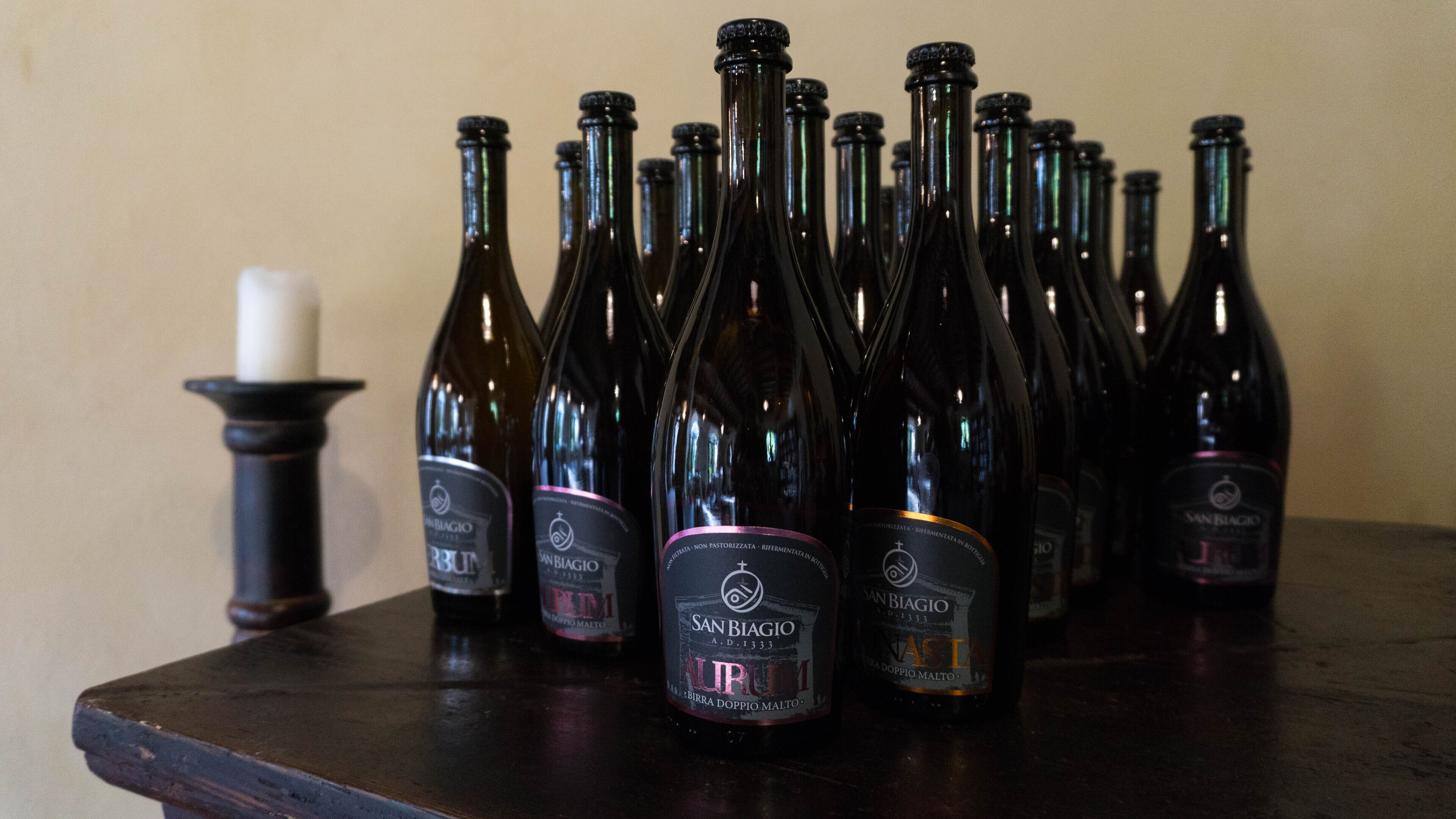 A collection of wine bottles on a wooden table.