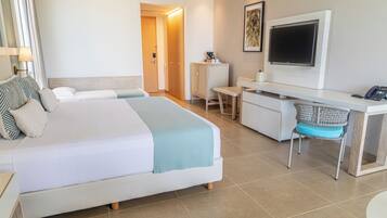 A hotel room with two beds, a desk, a chair, a television, and a cabinet.