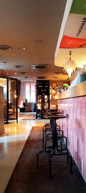 A restaurant interior with a bar area, seating, and a decorative ceiling. - DORMERO Hotel Kehl (Kehl)