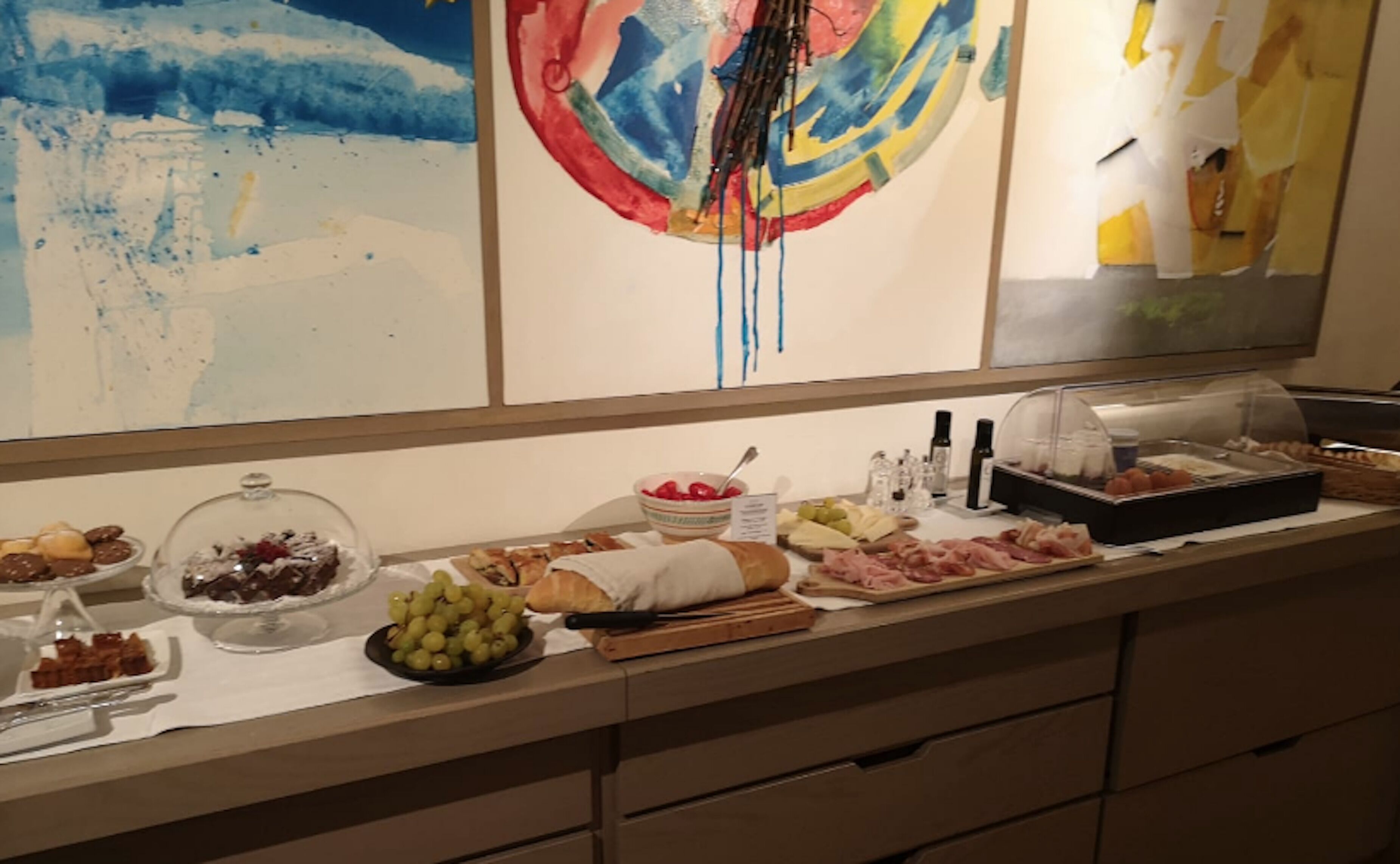 A buffet table with various food items and condiments.